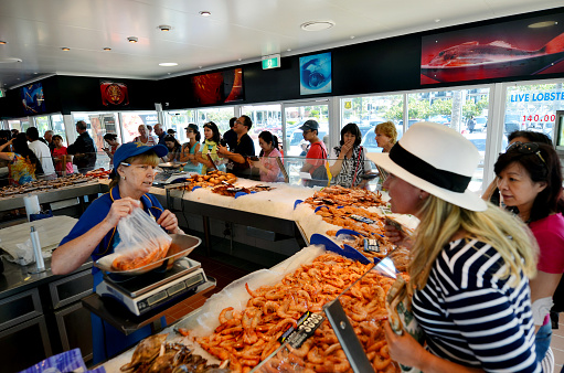 Gold Coast, Australia - October 05, 2014: Tourist and Australians buys seafood in Charis Seafood restaurnt. It's one of the most famous and largest seafood outlets in the Gold Coast Queensland, Australia.