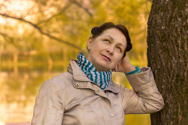 istock Elderly female at the birch in Park, sunset 534208384