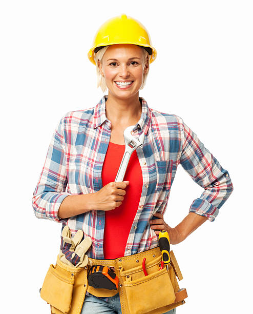 Female Construction Worker With Hand On Hip Holding Wrench Portrait of happy female construction worker with hand on hip holding wrench isolated over white background. Horizontal shot. woman wearing tool belt stock pictures, royalty-free photos & images