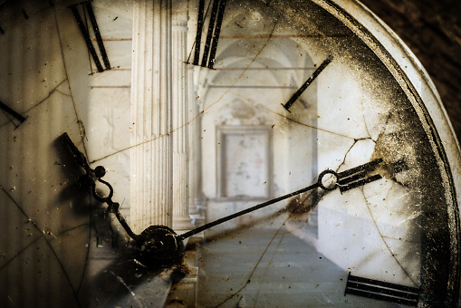 Double exposure of antique pocket watch and old architecture