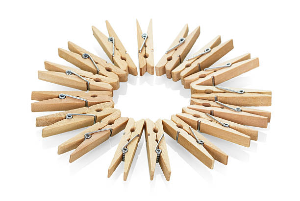 istock Wooden clothespins close-up isolated on white 534210518