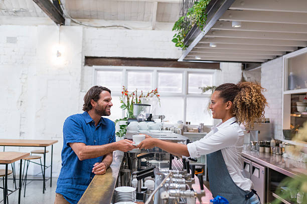 istock Aboriginal Female Barista Serving Coffee to Customer 534211738