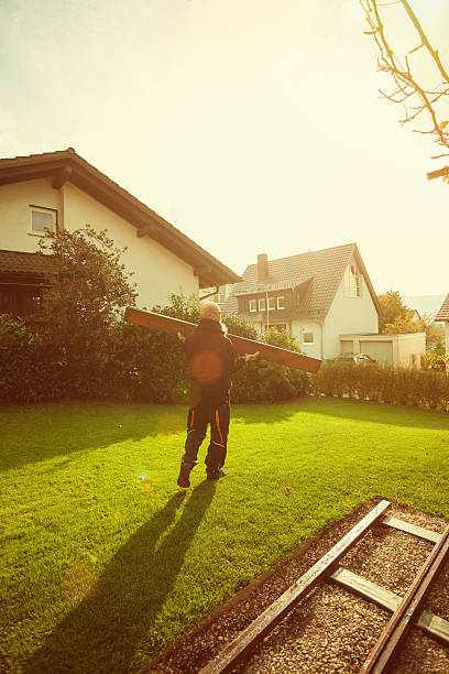 istock Manual worker in action carrying wooden plank 534212386