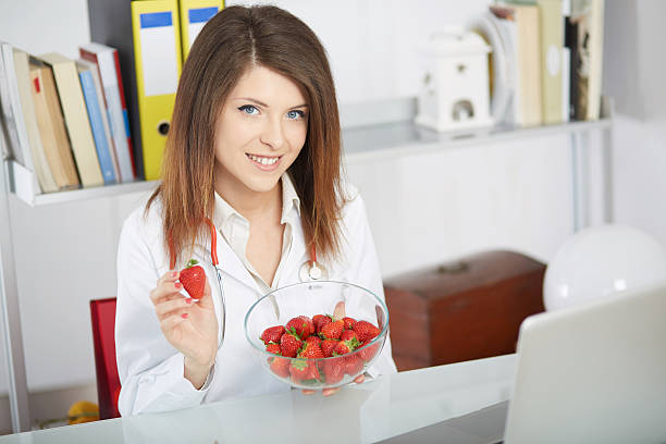 istock young nutritionist showing strawberries 534212416