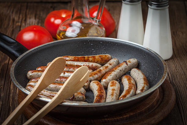 istock Fried white sausages in a cast iron skillet. 534213338