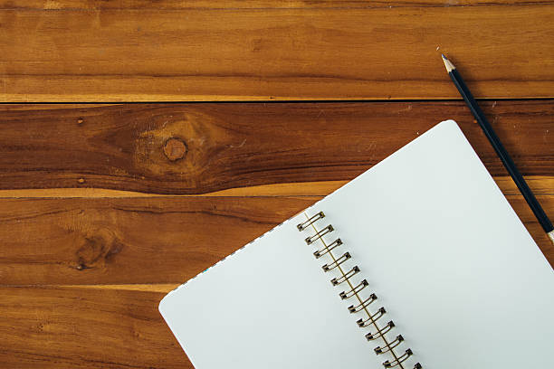 istock Blank notepad with pencil on office wooden table 534213486