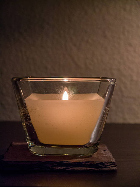istock Square glass witn lit candle within 534213750
