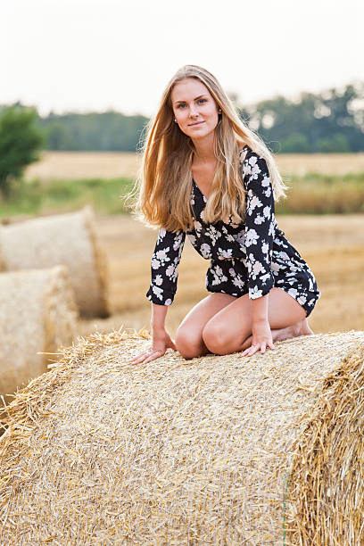 istock Blonde young woman kneeling on straw ball 534215896