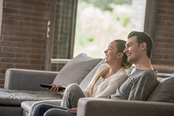 istock Loving couple watching tv at home 534215946
