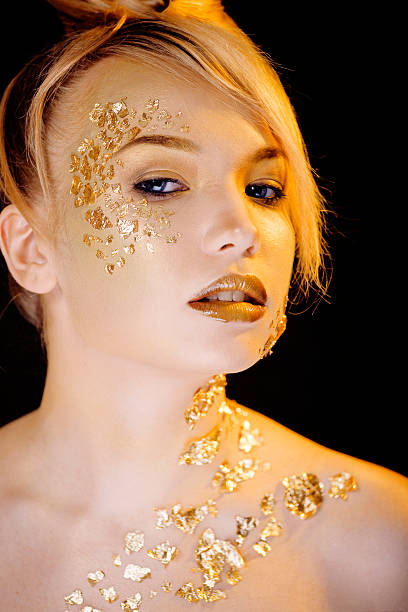 istock beauty blond woman with gold creative make up 534216506