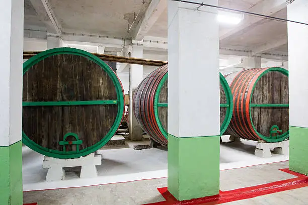 Wine barrels stacked in the old cellar of the winery, Bulgaria.