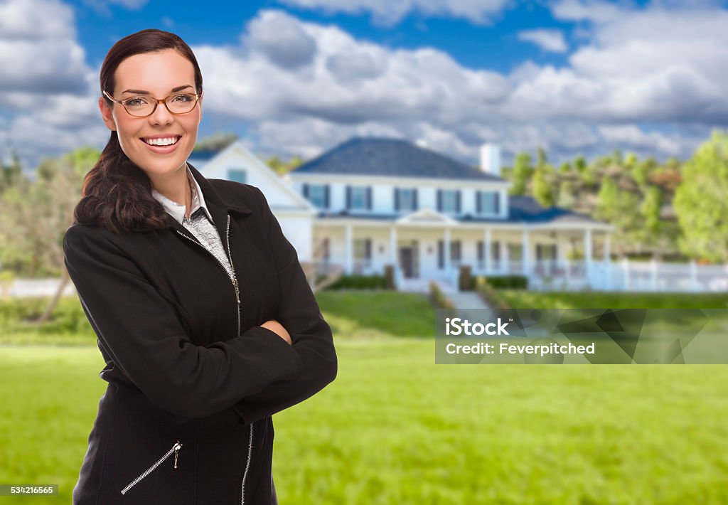 Mixed Race Woman in Front of Residential House Attractive Mixed Race Woman in Front of Beautiful New Residential House. 2015 Stock Photo