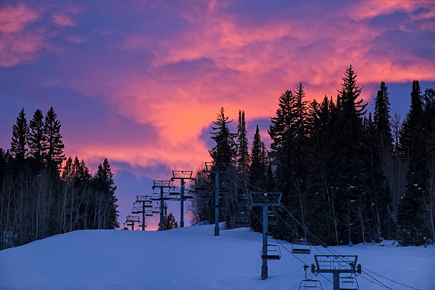 Ski Runs Silhouetted at Sunset with Dramatic Pink Clouds Ski Runs Silhouetted at Sunset with Dramatic Pink Clouds - Landscape scenic looking up mountain with ski slopes and wispy pink clouds lighting up at sunset. Aspen, Colorado USA. buttermilk mountain stock pictures, royalty-free photos & images