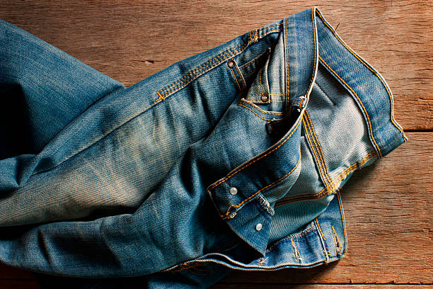 istock jeans on a wooden background . Vintage concept , soft focus 534217772