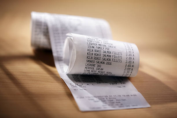 Shopping till receipt Grocery shopping list till roll printout on a wooden table receipt photos stock pictures, royalty-free photos & images