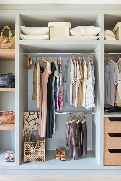 istock white wardrobe with shirts and pants hanging 534217850