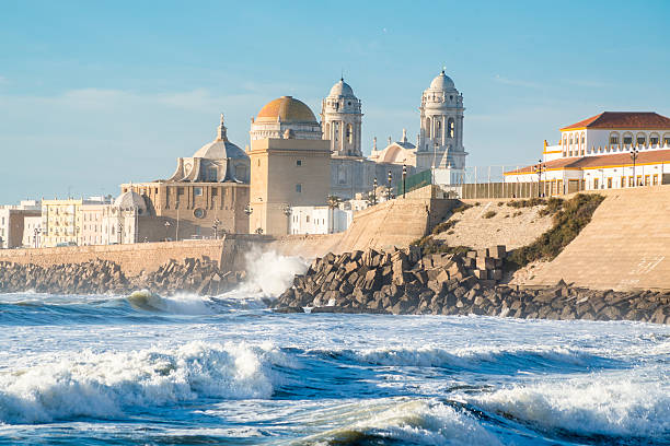 Ancient Cadiz Cathedral. Spain Ancient Cadiz Cathedral. The waves on the winter Atlantic Ocean. Spain cadiz province stock pictures, royalty-free photos & images