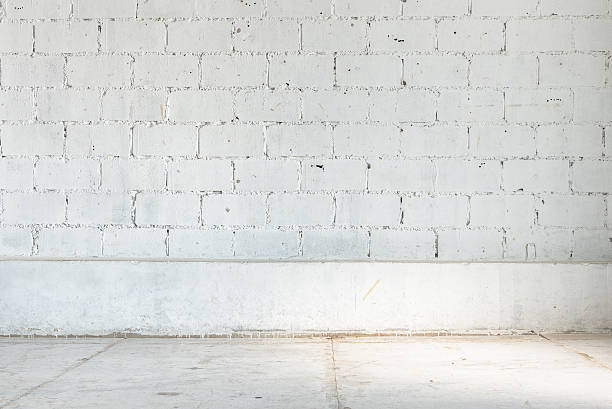 istock empty room with white brick wall and concrete floor 534219584