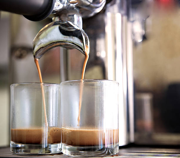 istock prepares espresso in his coffee shop; close-up 534219723