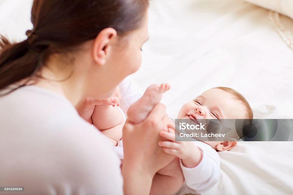 Mother with baby playing and laughing. A happy family Mother and baby playing and laughing. A happy family Baby - Human Age Stock Photo