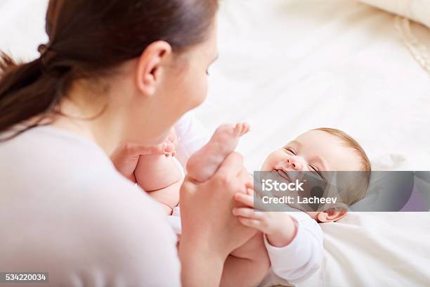 Mother With Baby Playing And Laughing A Happy Family Stock Photo - Download Image Now