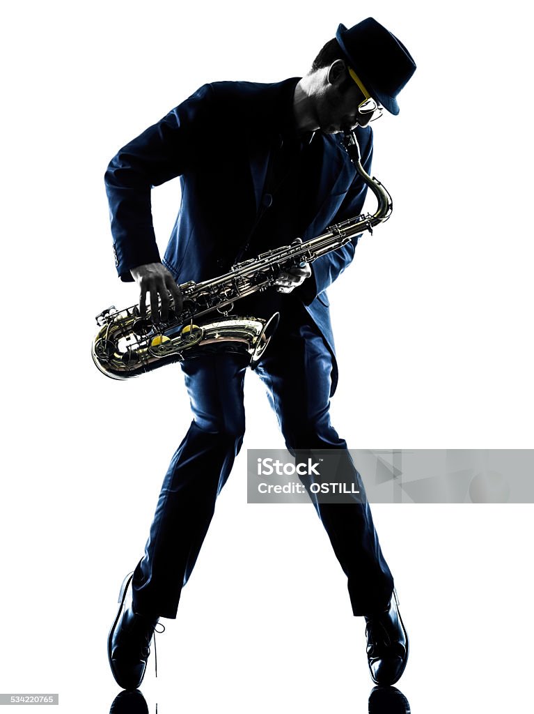 man saxophonist playing saxophone player  silhouette one caucasian man  saxophonist playing saxophone player in studio silhouette isolated on white background Saxophonist Stock Photo