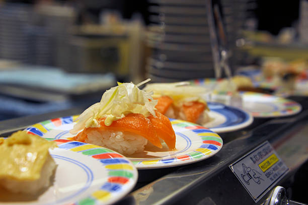 salmon sushi at a conveyor belt stock photo