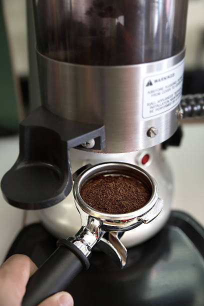 istock prepares espresso in his coffee shop; close-up 534223151