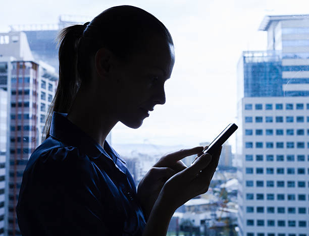 istock Woman using mobile phone in the office 534223709