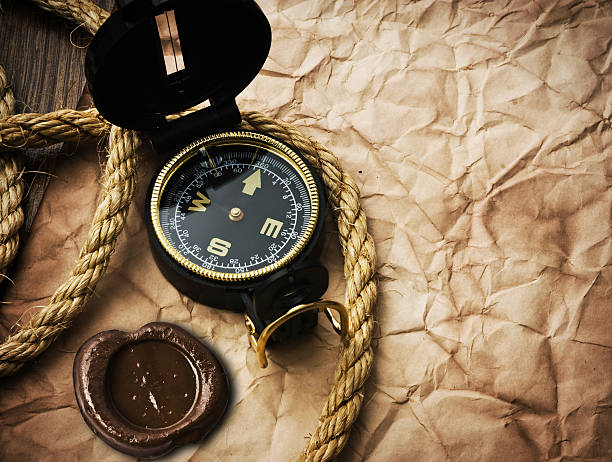 istock compass and rope on old paper background 534224887