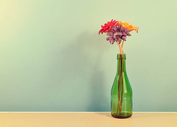 istock Vintage  flower in green vase on a blue wall table 534225647