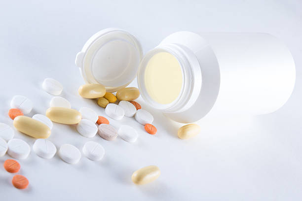 istock close up of colorful capsules pouring from plastic bottle 534227603