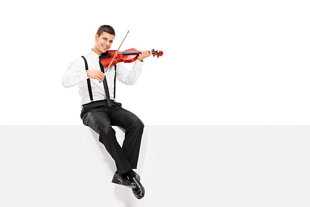 istock Male violinist playing seated on a blank panel 534265917