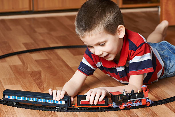 istock Happy little boy playing with railway 534269509