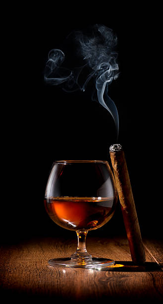 Scotch and cigar Wineglass of scotch and cigar on wooden table cigar photos stock pictures, royalty-free photos & images