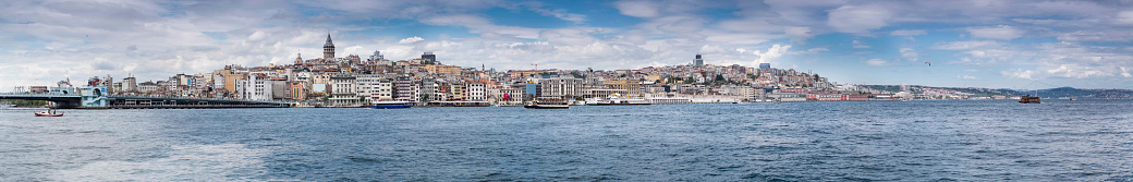 A bay with moored boats on a sunny afternoon. Blue skies with green hills surrounding