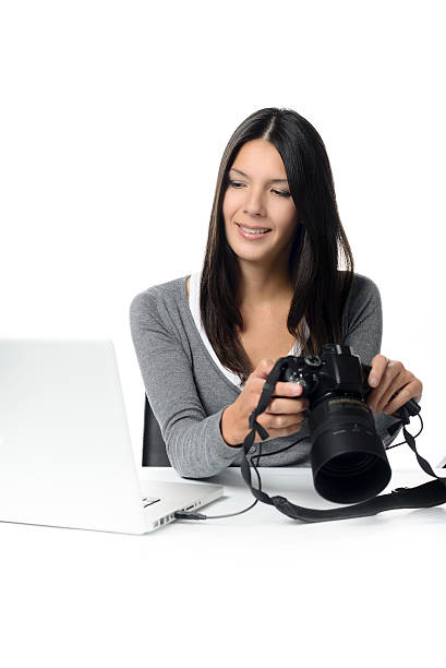 istock Female photographer checking an image on a camera 534273215