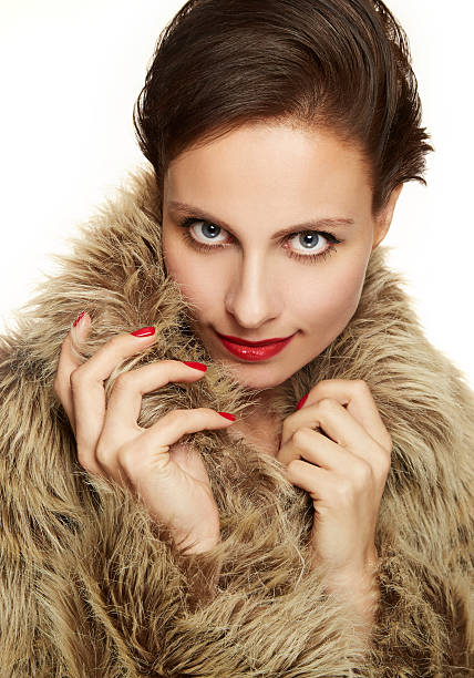 istock Beautiful woman with fur coat.red nails with make up. 534273875