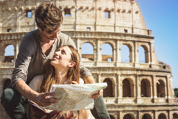 istock Tourists with guide and map in front of the Coliseum 534274031