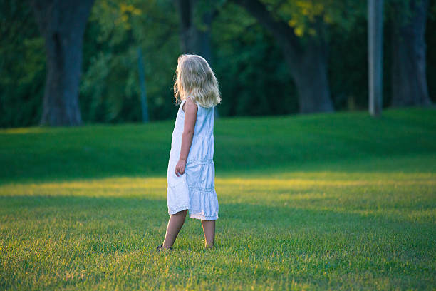 istock Little girl standing in a park 534274073