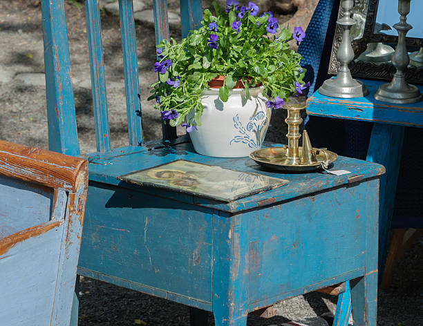 Stand at an outdoor market with antique wooden furniture. stock photo
