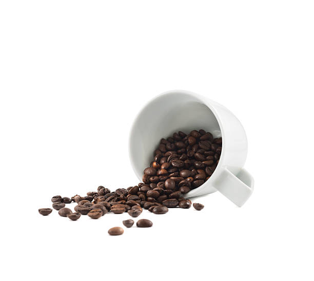 istock Spilled coffee beans from the cup isolated 534305760