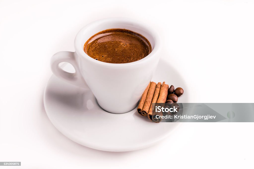 Coffee Cup, Cinnamon & Coffee Beans A cup of coffee with cinnamon sticks and roasted coffee beans isolated on a white backround 2015 Stock Photo