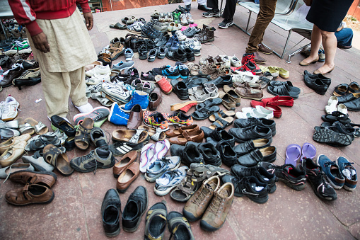 Many pair of shoes, which must be left at the entrance of Mosque. Shot on the Jama Masjid in New Delhi, India.
