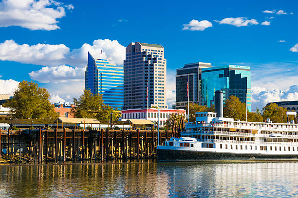 istock Sacramento skyline with blue sky, clouds, riverboat, and Sacramento River 534306557
