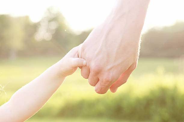 istock Father Holding Little Girl's Hand 534307149