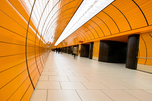 Passers-by in an orange tunnel