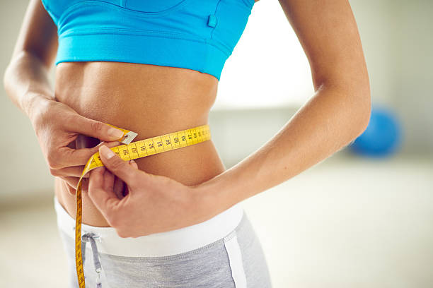 istock Woman measuring waist 534307544