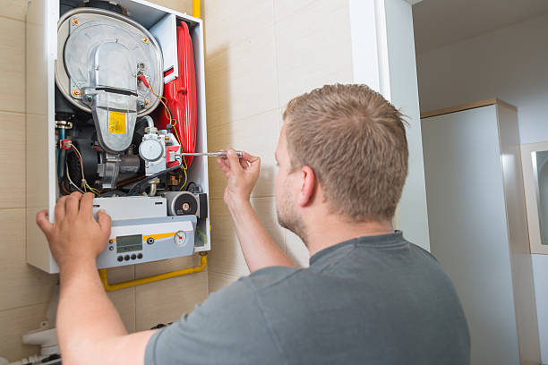 Technician repairing Gas Furnace stock photo