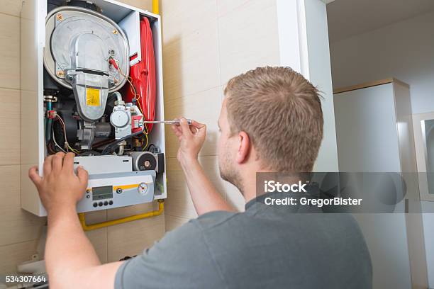 Technician Repairing Gas Furnace Stock Photo - Download Image Now - Furnace, Boiler, Radiator - Heater